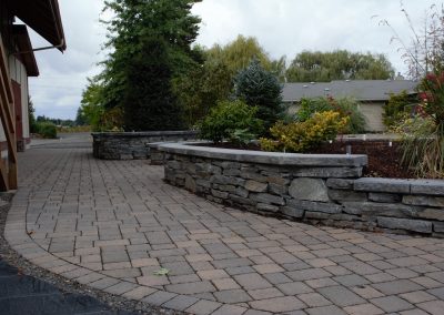 stone retaining wall next to walkway