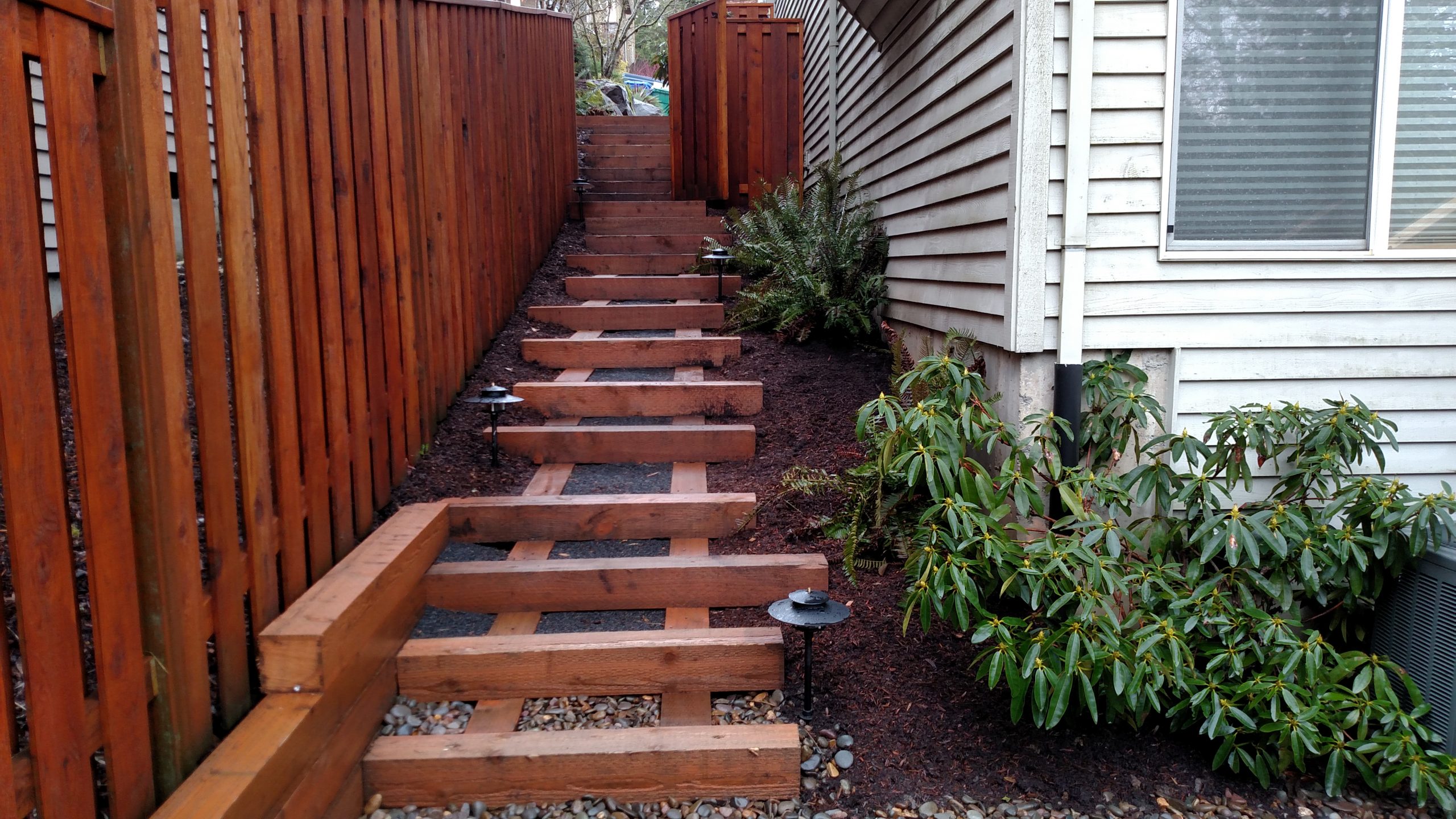 wood stairs next to home that match fence